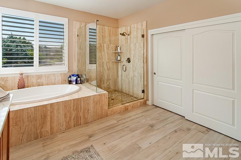 585 Magistrate Court Reno, NV 89521 - Photo 14 of 22 a spacious bathroom with a tub shower and a sink
