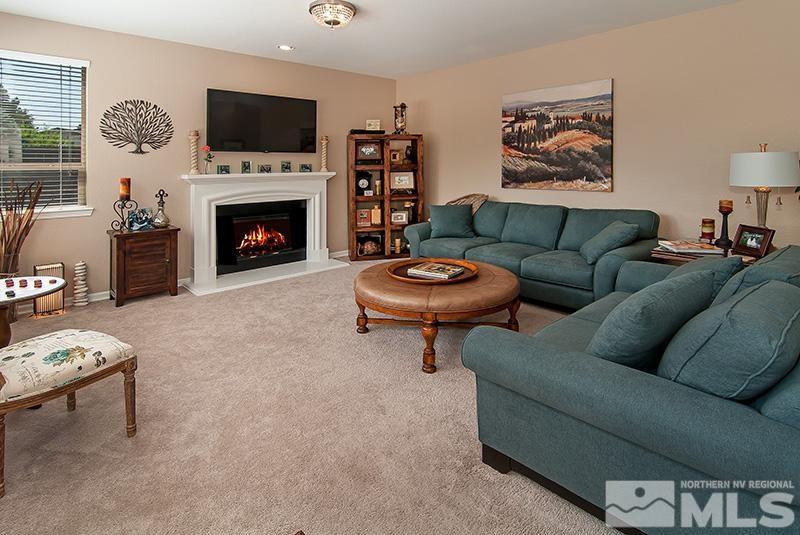 585 Magistrate Court Reno, NV 89521 - Photo 5 of 22 a living room with furniture a flat screen tv and a fireplace