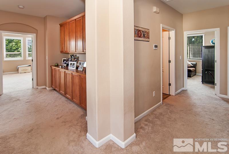585 Magistrate Court Reno, NV 89521 - Photo 8 of 22 a view of a hallway to a livingroom with furniture and windows