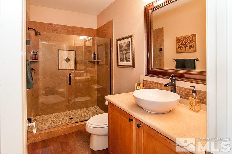 585 Magistrate Court Reno, NV 89521 - Photo 9 of 22 a bathroom with a sink a toilet and shower