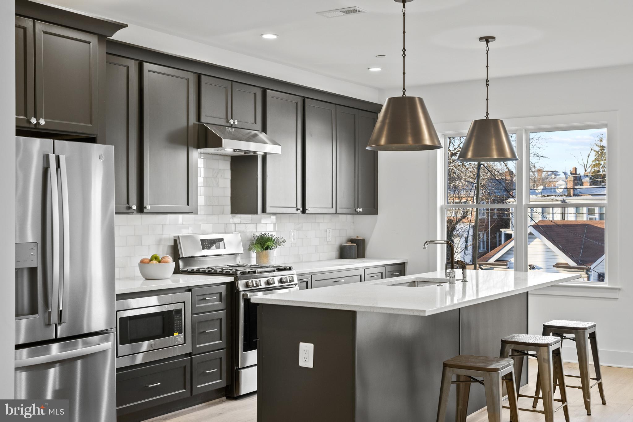 a kitchen with a sink cabinets and stainless steel appliances