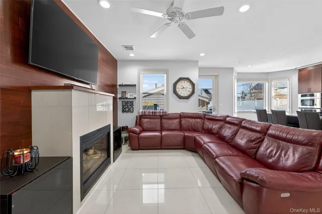 a living room with lots of furniture and a large window