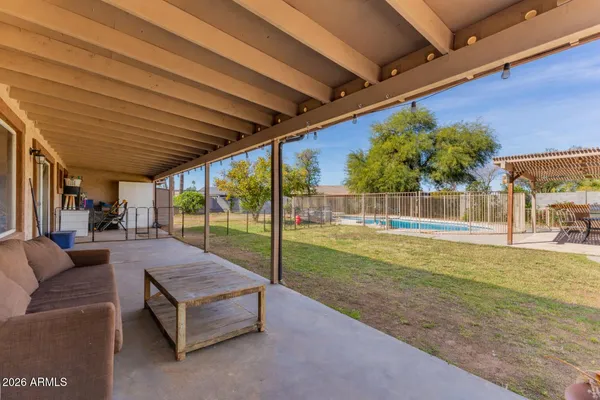 a view of patio with a table and chairs under an umbrella