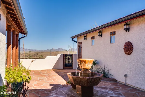 a bedroom with a large bed a flat tv screen and dresser