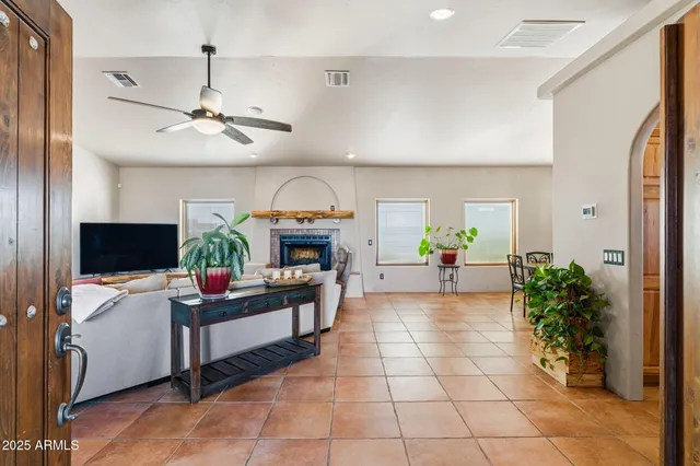 a living room with furniture and a book shelf