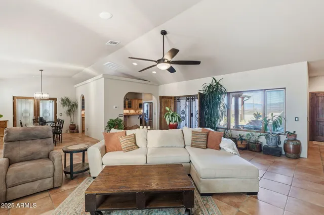 a view of a living room with a bed and wooden floor