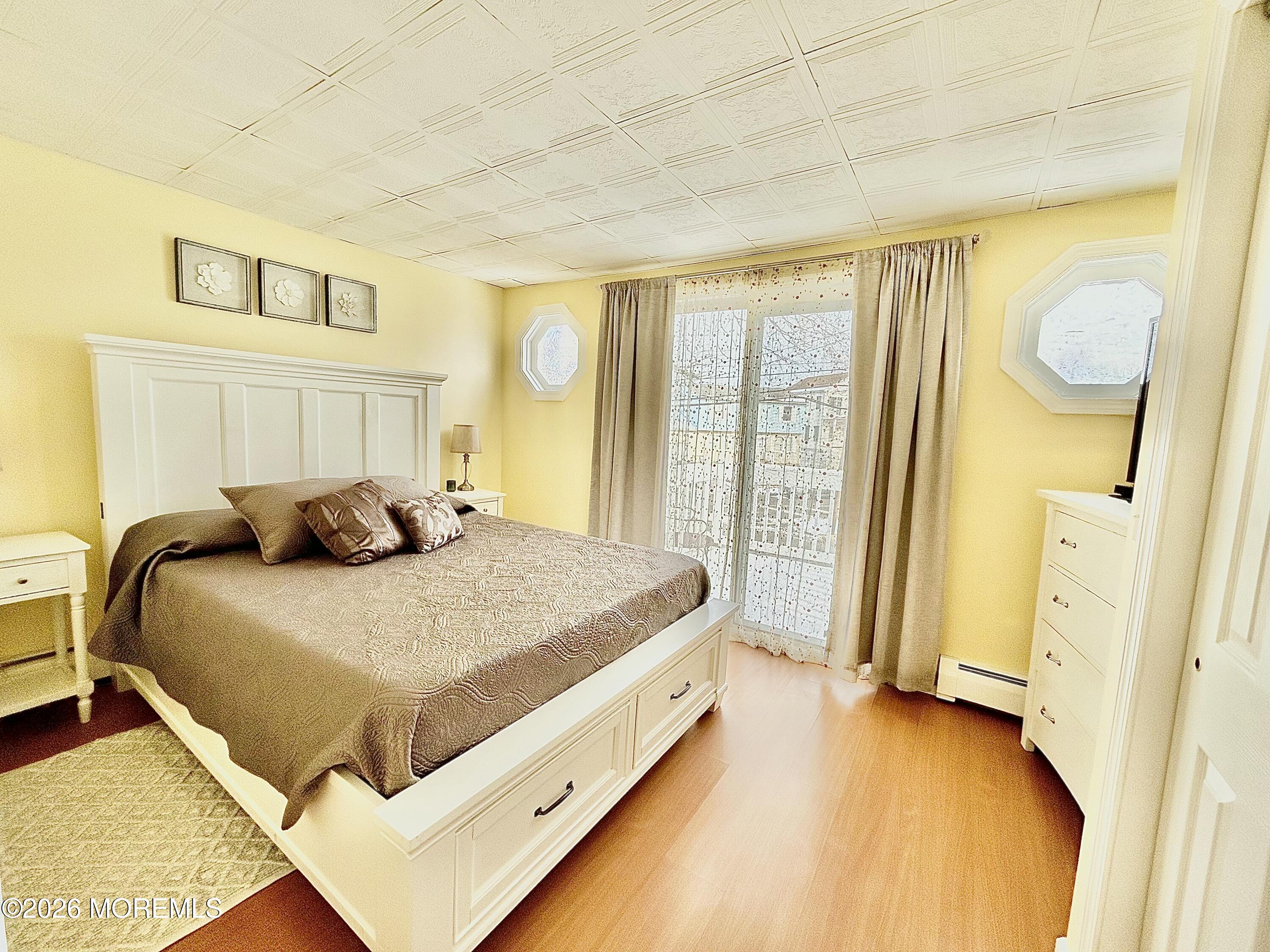 109 Poole Avenue Union Beach, NJ 07735 - Photo 16 of 23 a bed sitting in a spacious bedroom next to a window