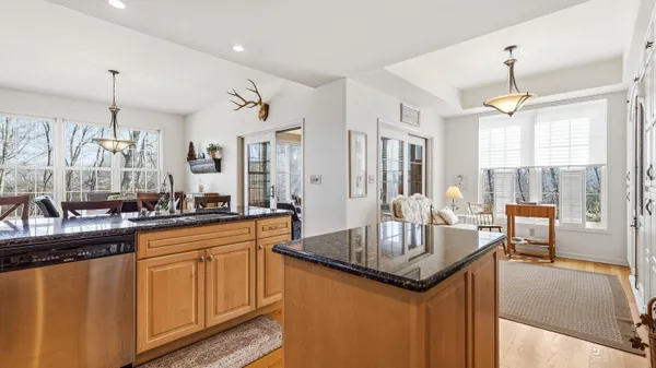 a kitchen with granite countertop a sink stove and refrigerator