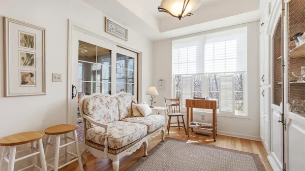 a living room with furniture and a floor to ceiling window