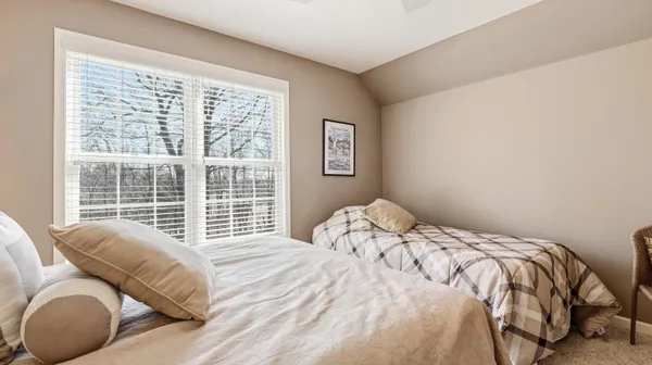 a bedroom with a bed and a large window