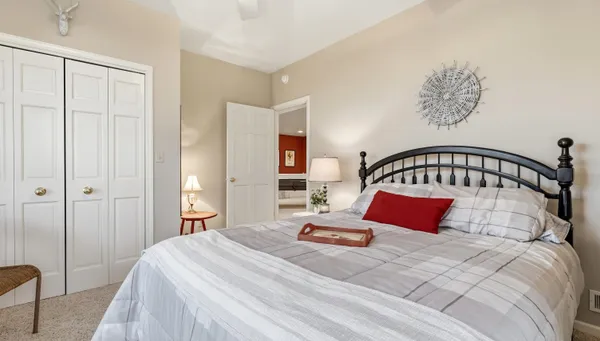 a bedroom with bed and wooden floor