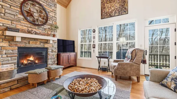 a living room with furniture a flat screen tv and a fireplace