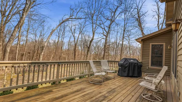 a view of balcony with wooden floor and fence