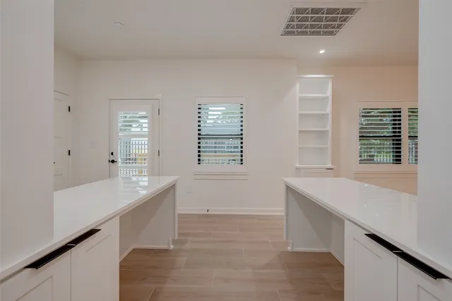 a room with a large counter top and natural light