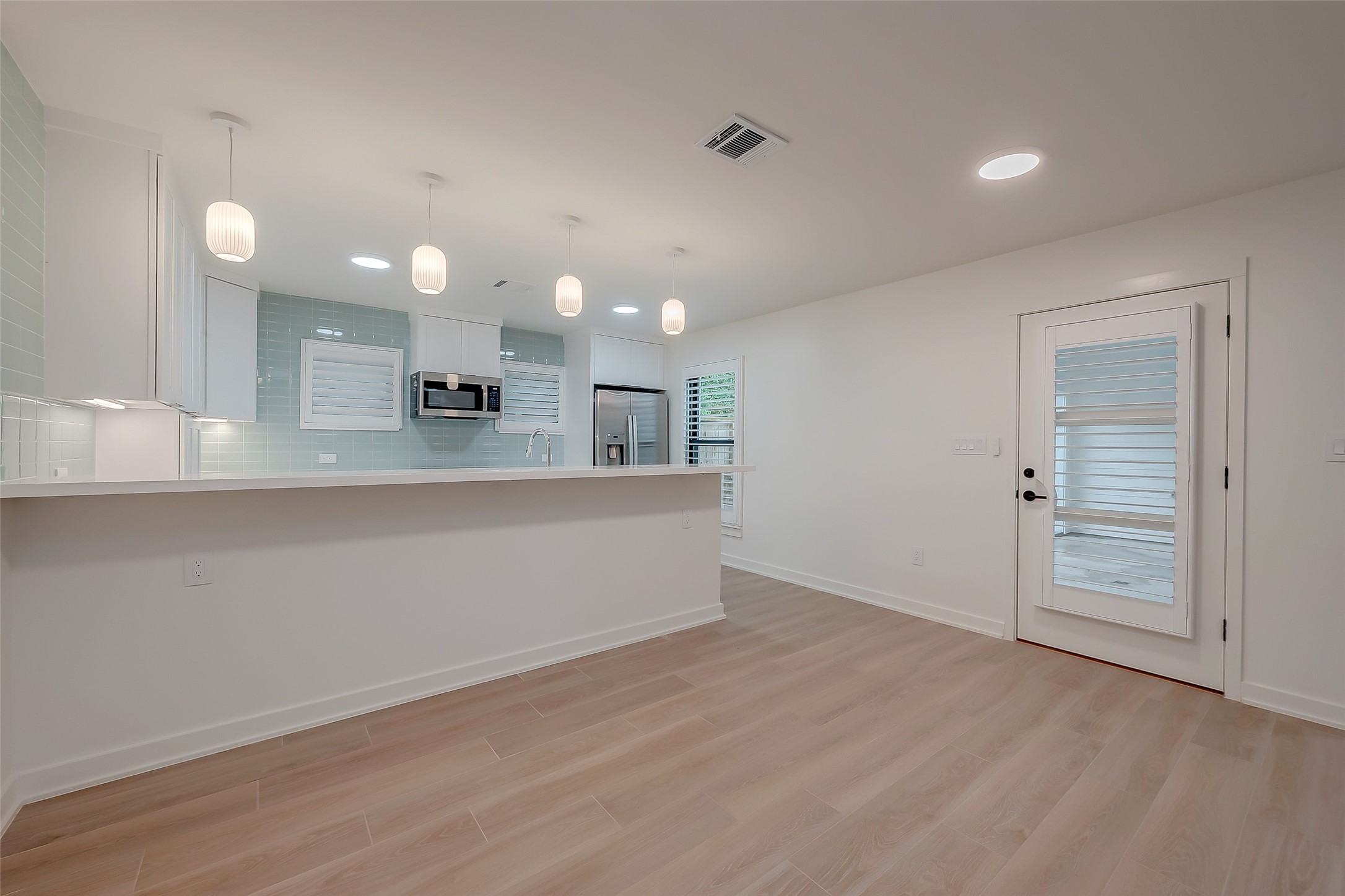 2702 Delano Street Houston, TX 77004 - Photo 17 of 45 an empty room with wooden floor and windows