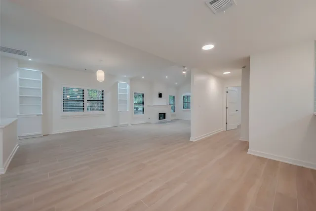 an empty room with a empty space and windows