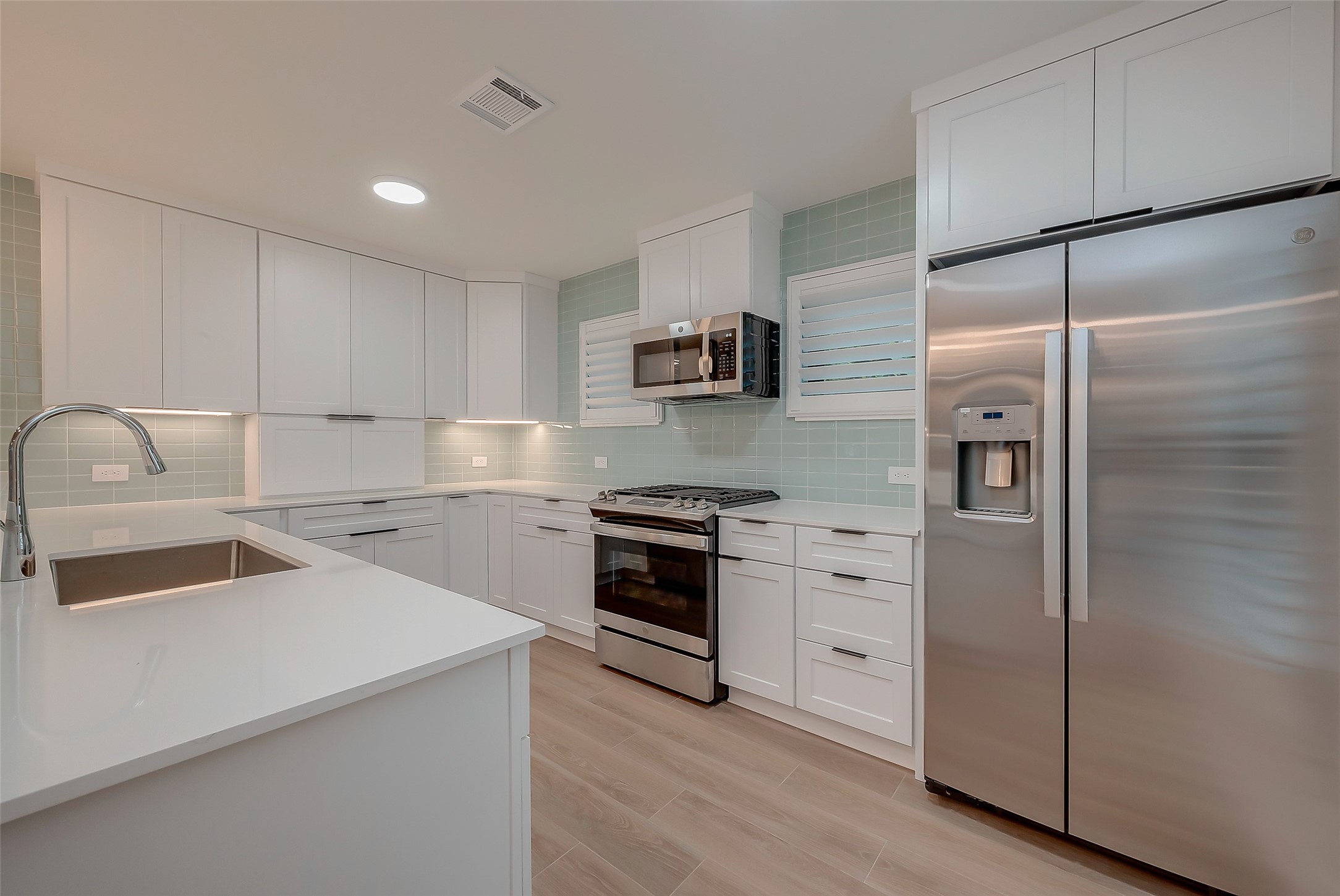 2702 Delano Street Houston, TX 77004 - Photo 19 of 45 a kitchen with a refrigerator sink and stove