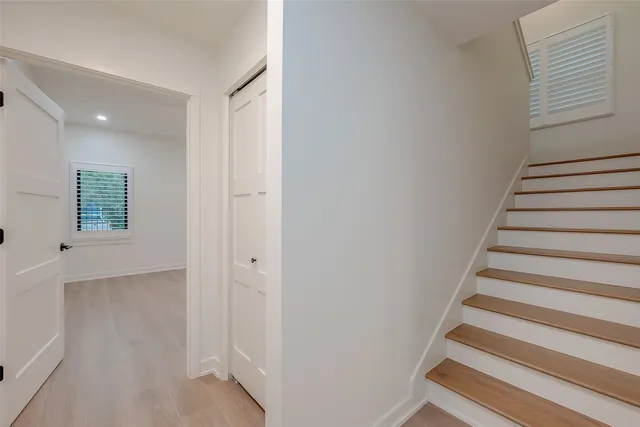 a view of entryway with wooden floor and stairs
