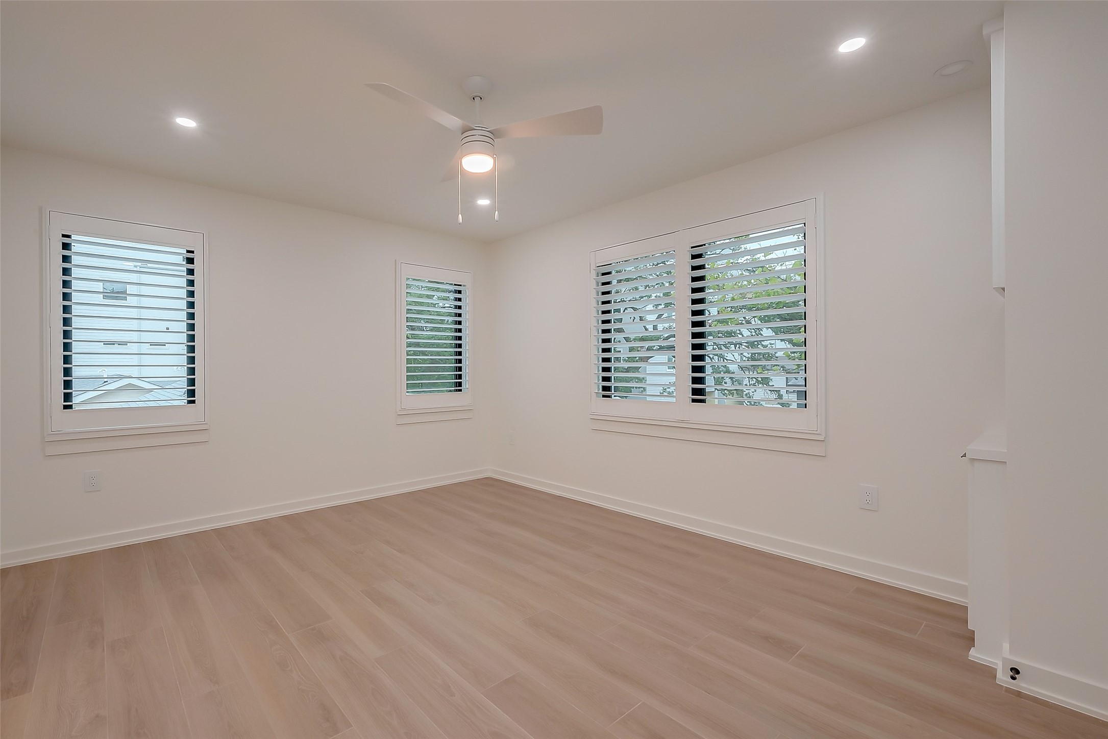 2702 Delano Street Houston, TX 77004 - Photo 27 of 45 an empty room with wooden floor and windows