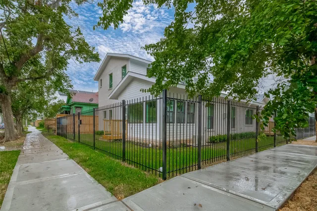a view of a park with iron fence