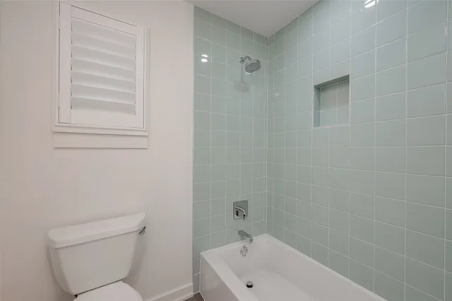 a bathroom with a toilet and a bathtub