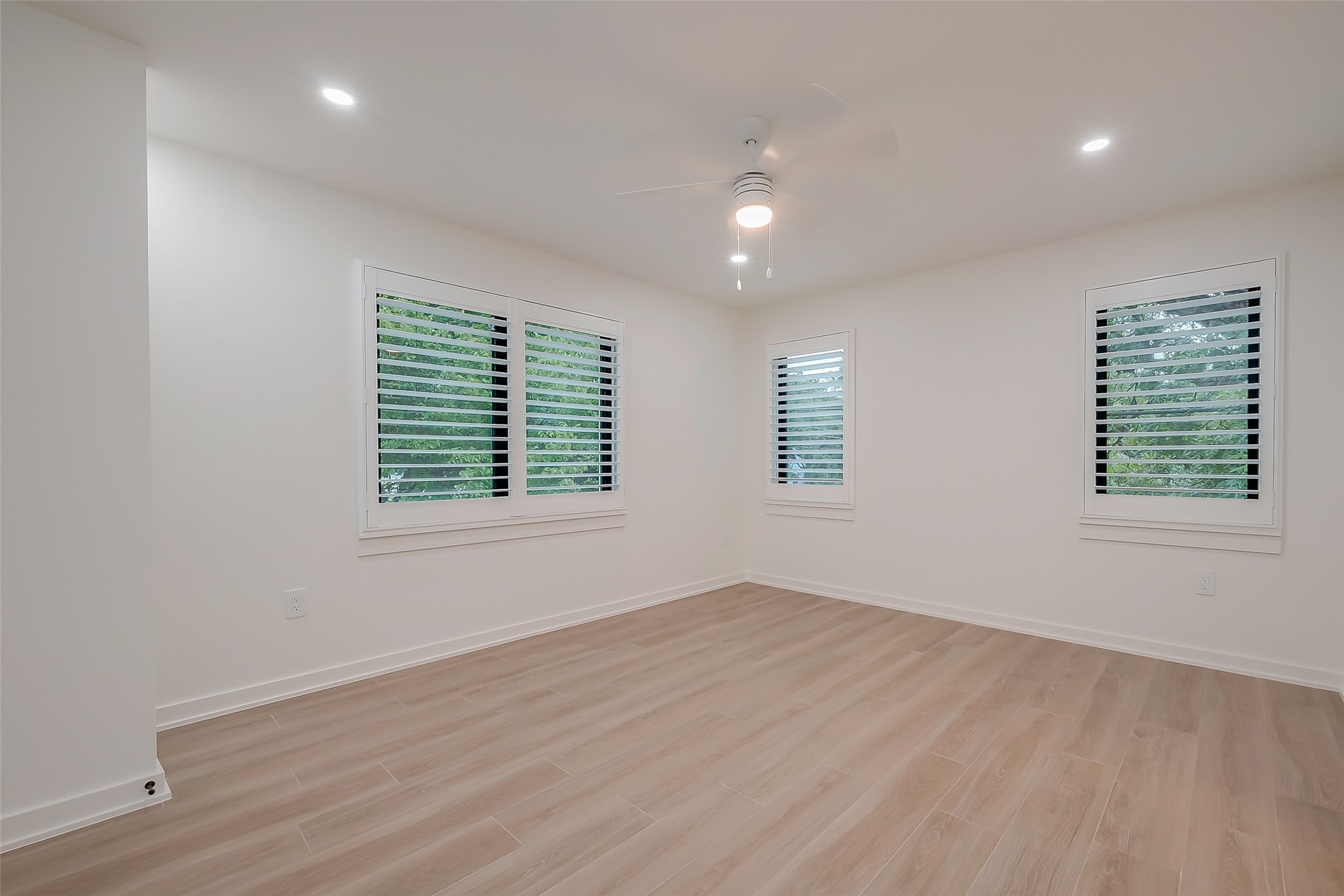 2702 Delano Street Houston, TX 77004 - Photo 32 of 45 an empty room with wooden floor and windows