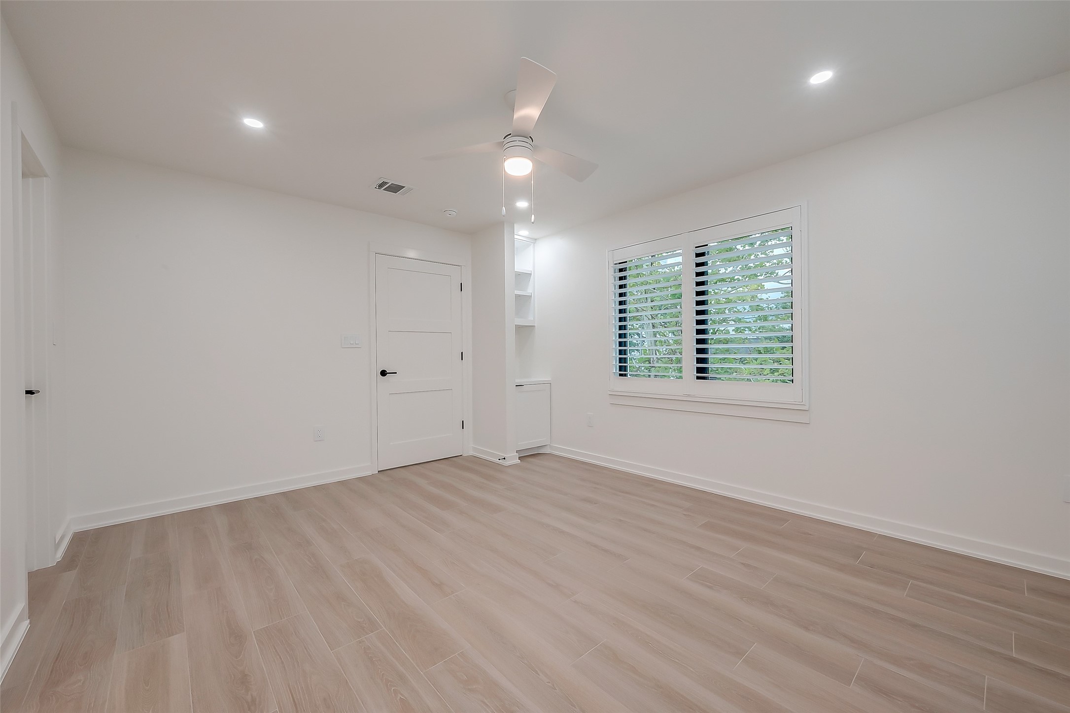 2702 Delano Street Houston, TX 77004 - Photo 33 of 45 an empty room with wooden floor and windows