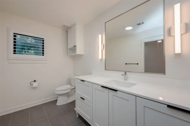 a bathroom with a shower sink and mirror