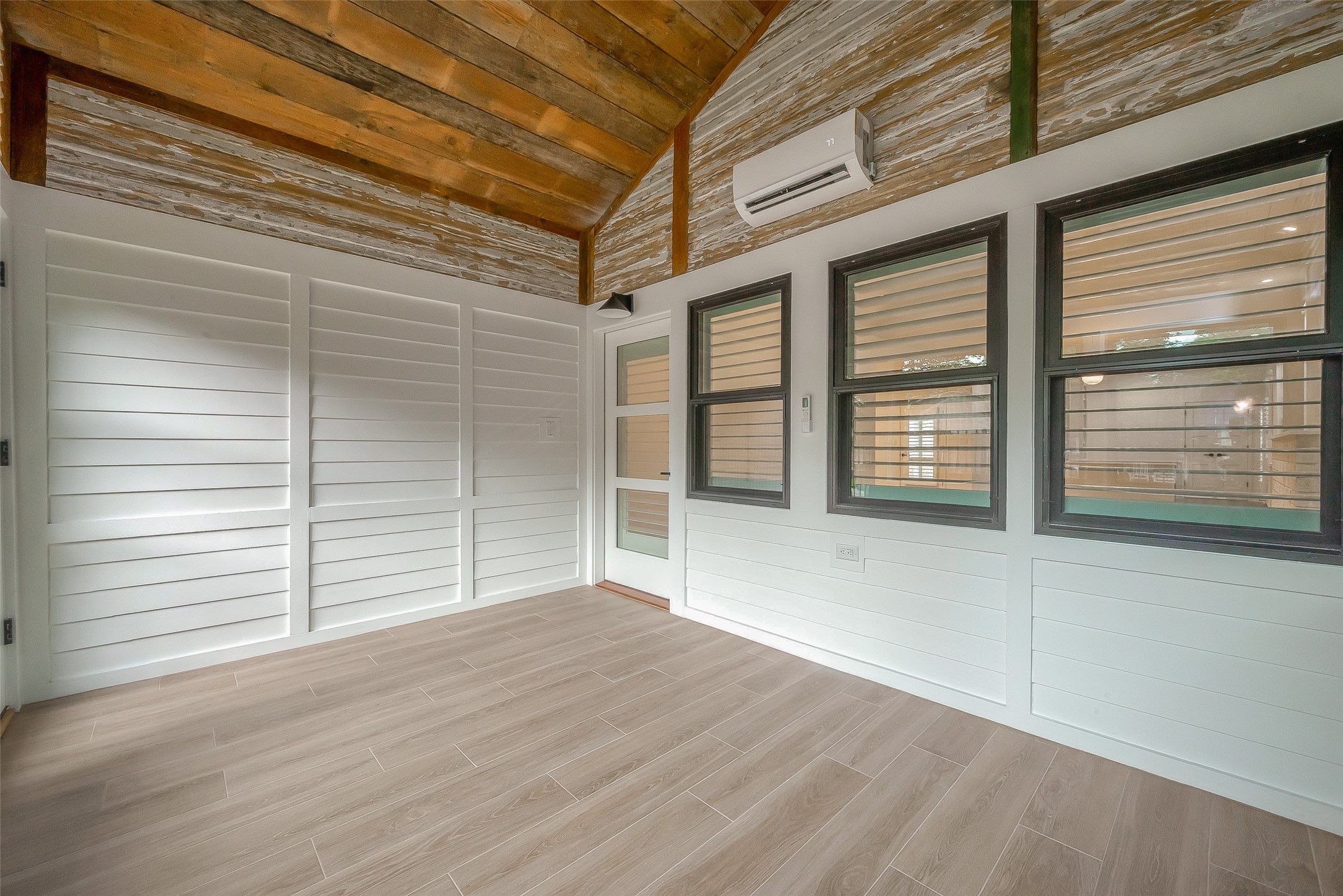 2702 Delano Street Houston, TX 77004 - Photo 43 of 45 an empty room with wooden floor and windows