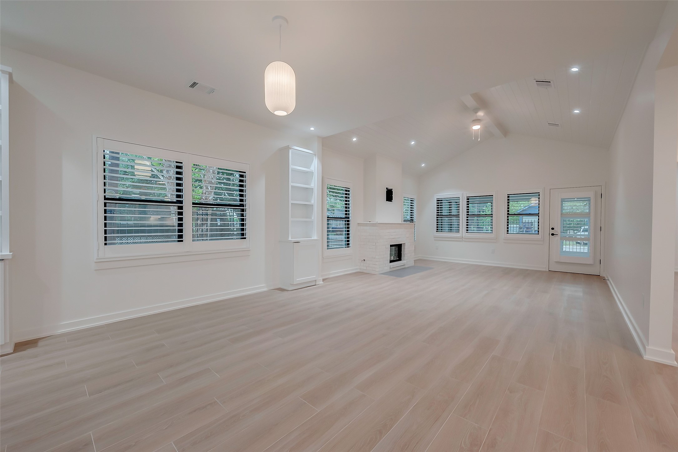 2702 Delano Street Houston, TX 77004 - Photo 6 of 45 an empty room with wooden floor and windows
