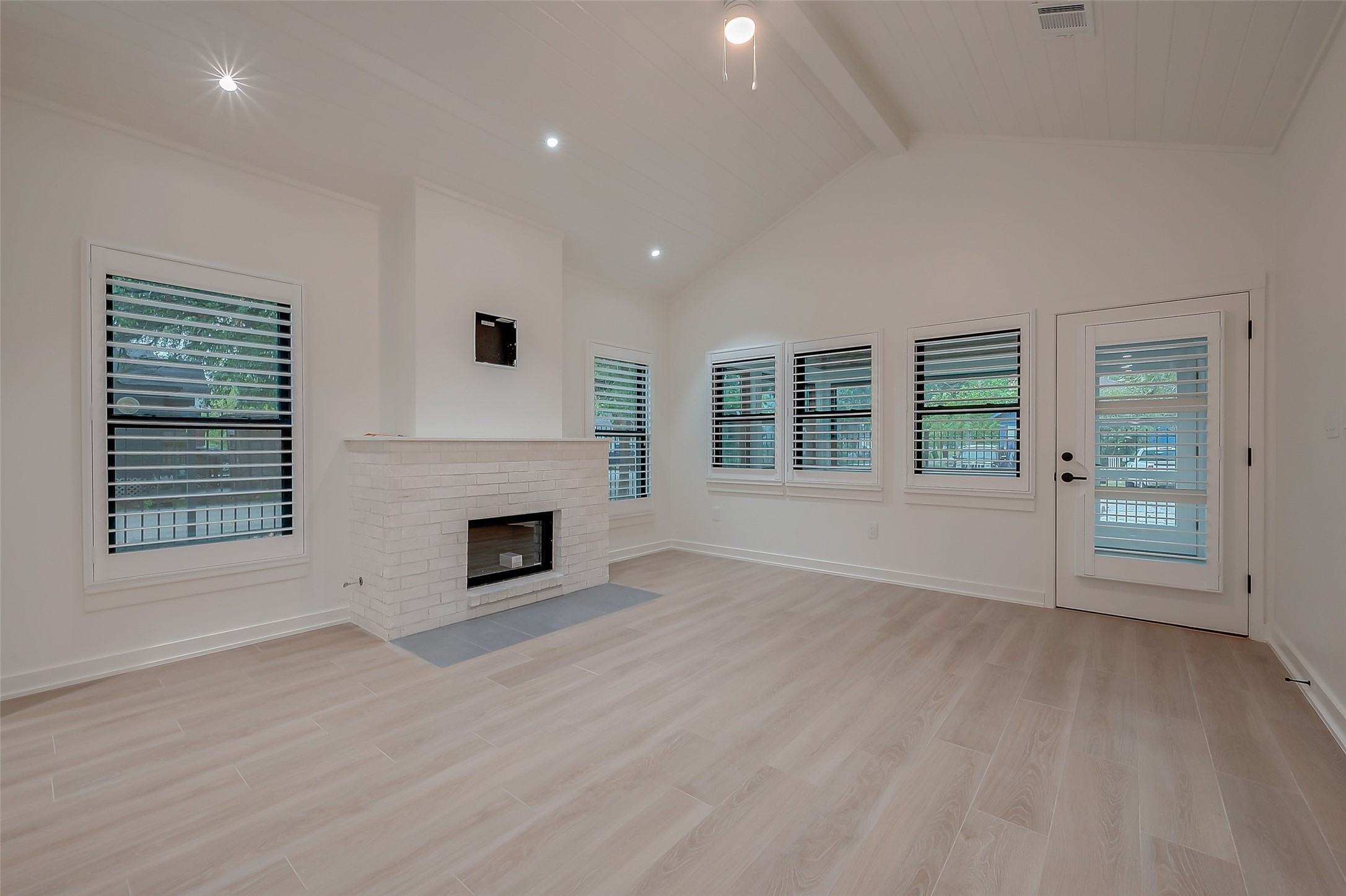 2702 Delano Street Houston, TX 77004 - Photo 7 of 45 an empty room with windows and fireplace