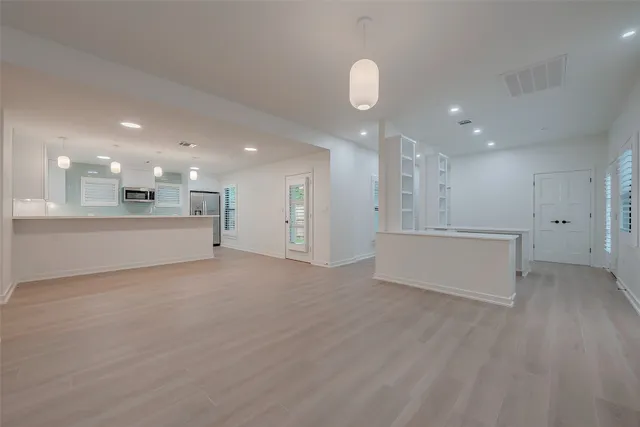 a view of an empty room with kitchen appliances