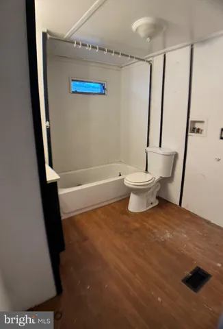 a bathroom with a white toilet and a shower