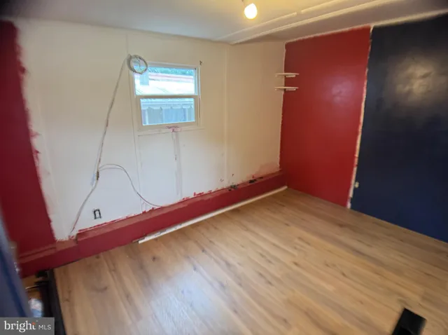 a view of a room with wooden floor and window