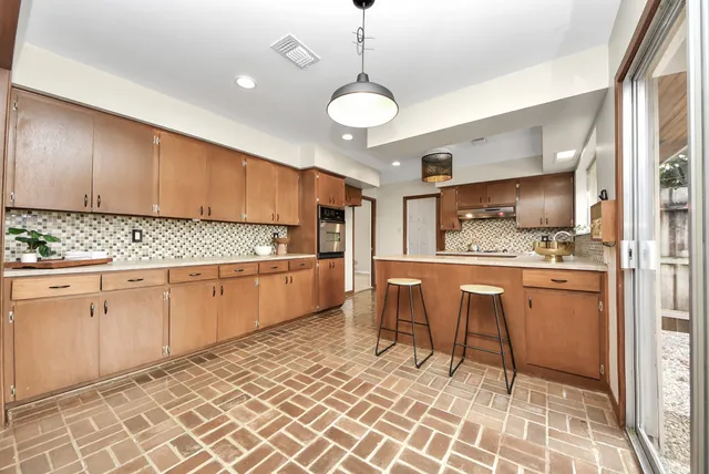 a kitchen with granite countertop cabinets a counter space and stainless steel appliances