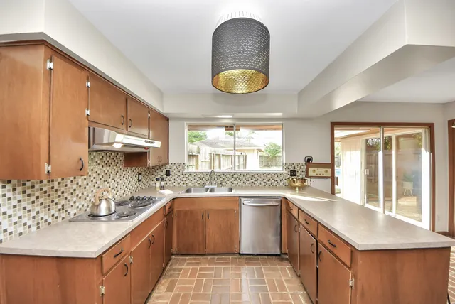 a large kitchen with a large window