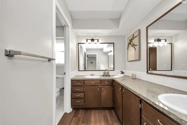 a spacious bathroom with a granite countertop sink mirror and a
