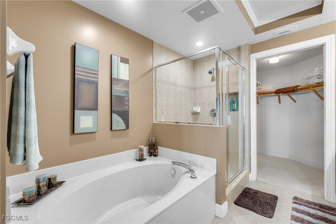 2743 First Street, Unit 1502 Fort Myers, FL 33916 - Photo 19 of 35 a bathroom with a tub a sink and mirrors