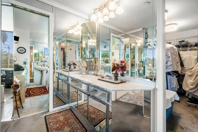 a bathroom with a double vanity sink toilet and a mirror