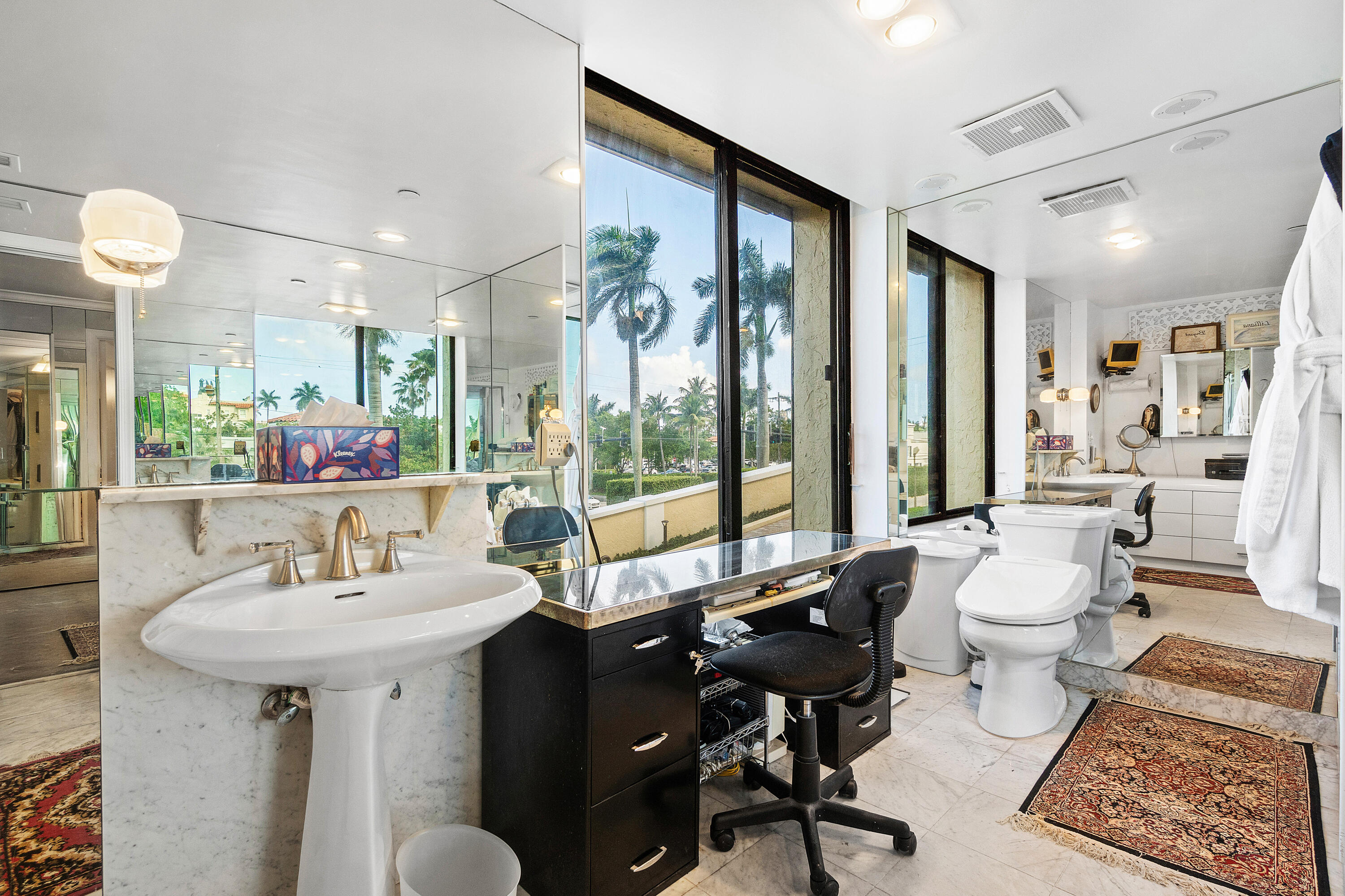 150 Bradley Place, Unit 101 Palm Beach, FL 33480 - Photo 27 of 38 a bathroom with a double vanity sink toilet and a mirror