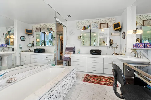 a large bathroom with a tub a sink a mirror and a shower