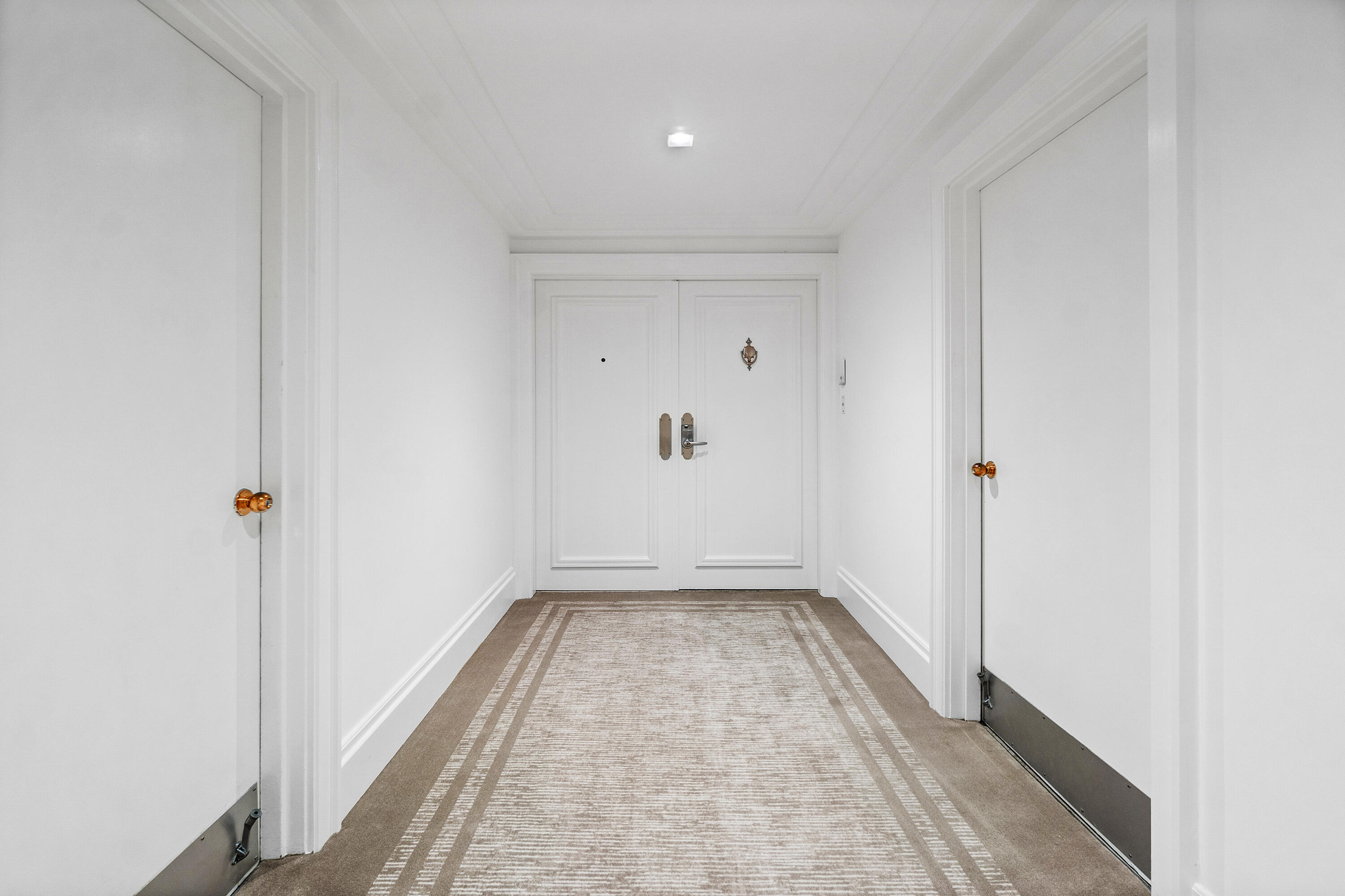 150 Bradley Place, Unit 101 Palm Beach, FL 33480 - Photo 3 of 38 a view of a hallway with wooden floor and a window