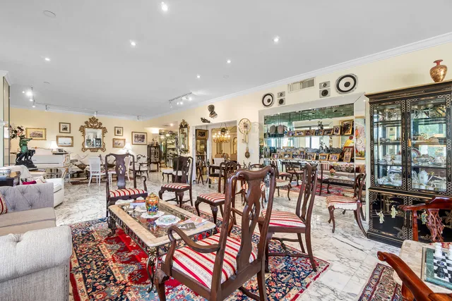 a living room with lots of furniture and view of kitchen