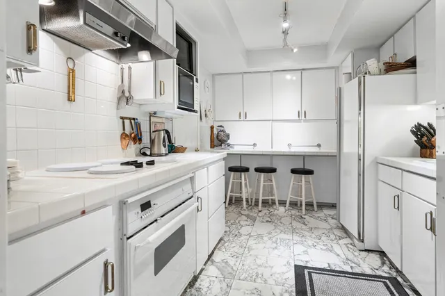 a kitchen with appliances cabinets and a sink