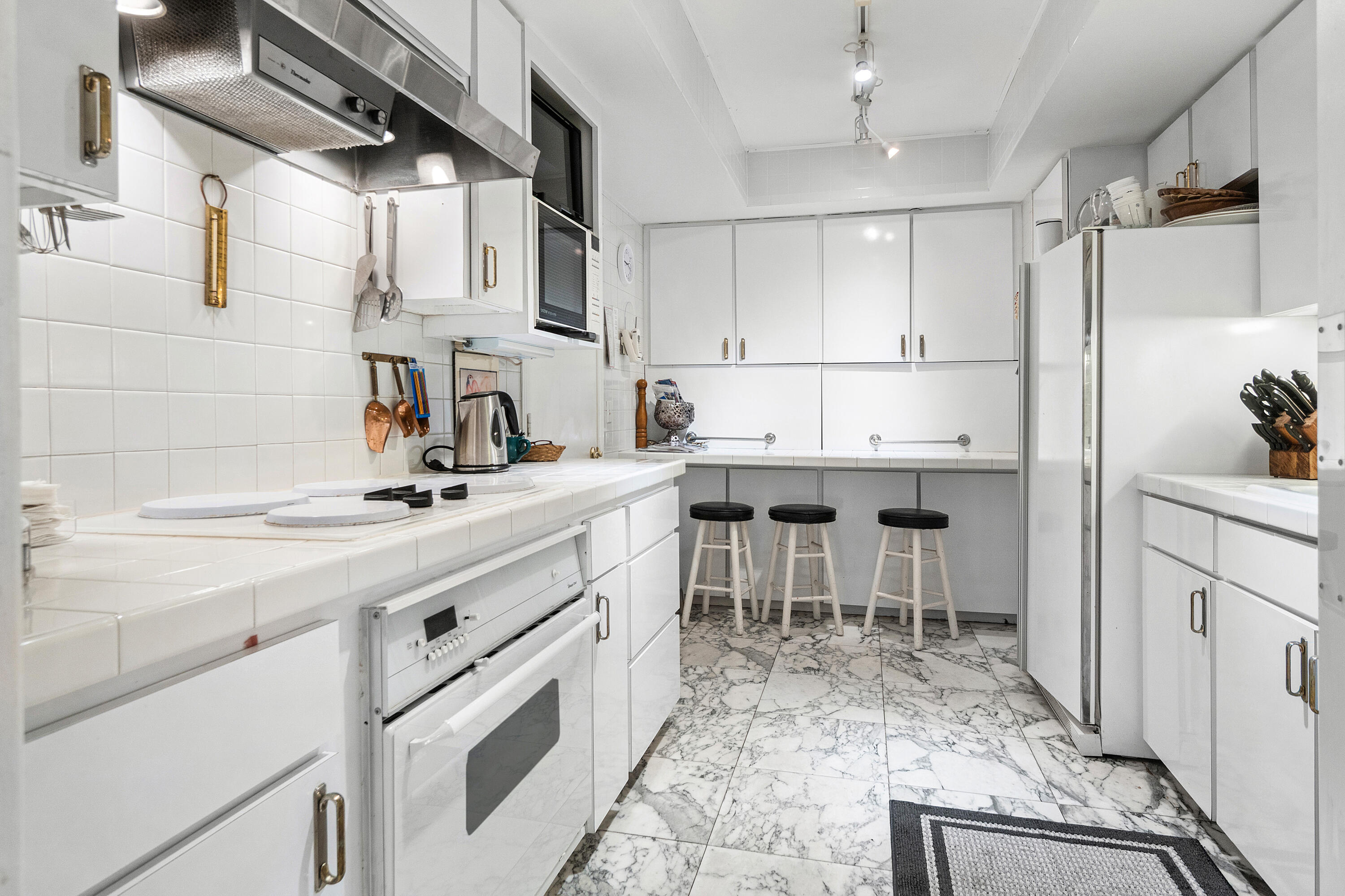 150 Bradley Place, Unit 101 Palm Beach, FL 33480 - Photo 6 of 38 a kitchen with appliances cabinets and a sink