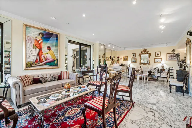 a living room with lots of furniture and painting on the wall