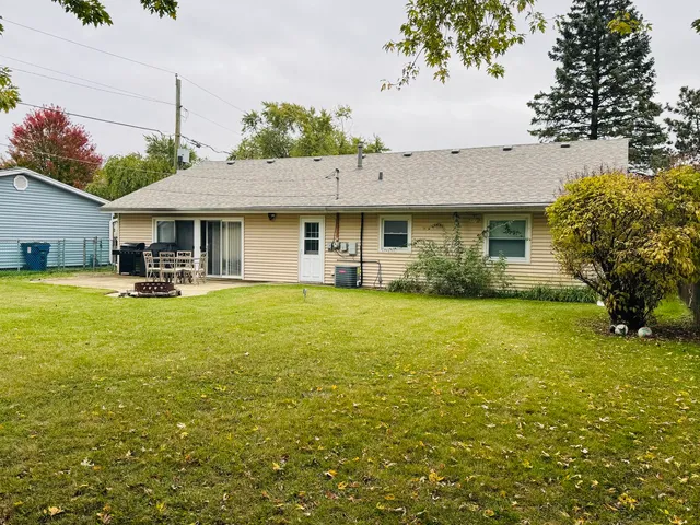 a front view of house with yard and outdoor seating