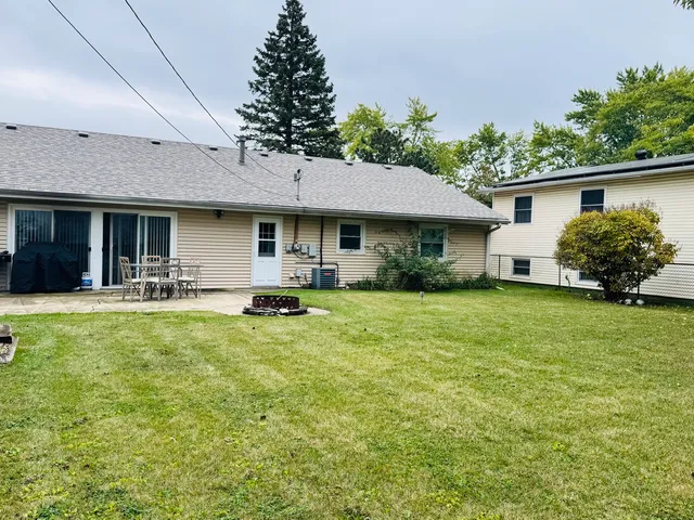 a front view of house with yard and outdoor seating