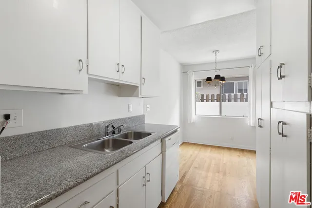 a kitchen that has a sink and cabinets
