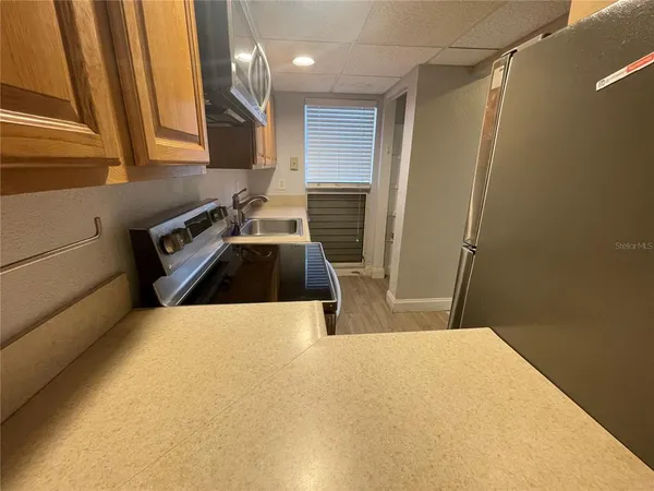 a kitchen with a sink a stove and a refrigerator
